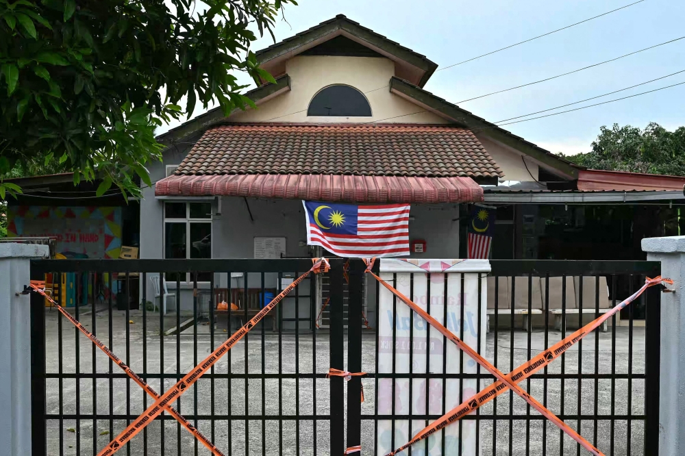 Social Welfare Department tape blocks off gates at the entrance to a care home after a crackdown by authorities in Subang Jaya September 12, 2024. — AFP pic