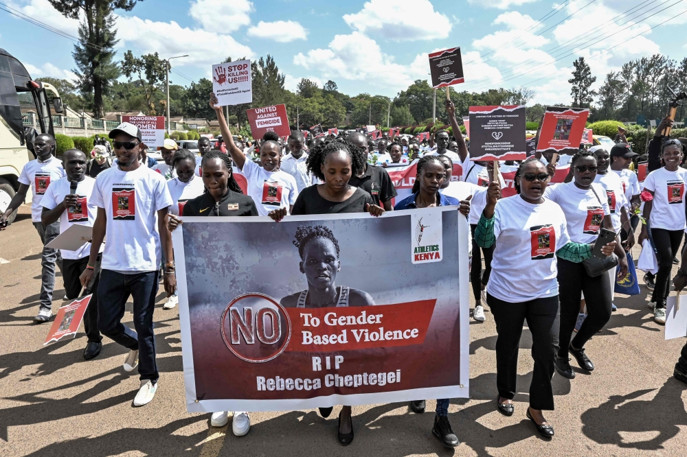 Activists and athletes carry a banner as they march through Eldoret, western Kenya, on September 13, 2024, to demonstrate against the murder of women in Kenya after Rebecca Cheptegei lost her life. — AFP pic