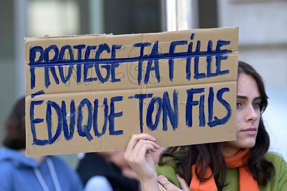 A protestor holds a placard reading ‘Protect your daughter (crossed out) - educate your son’ during a demonstration in support of Gisele Pelicot in Rennes, western France on September 14, 2024. — AFP pic