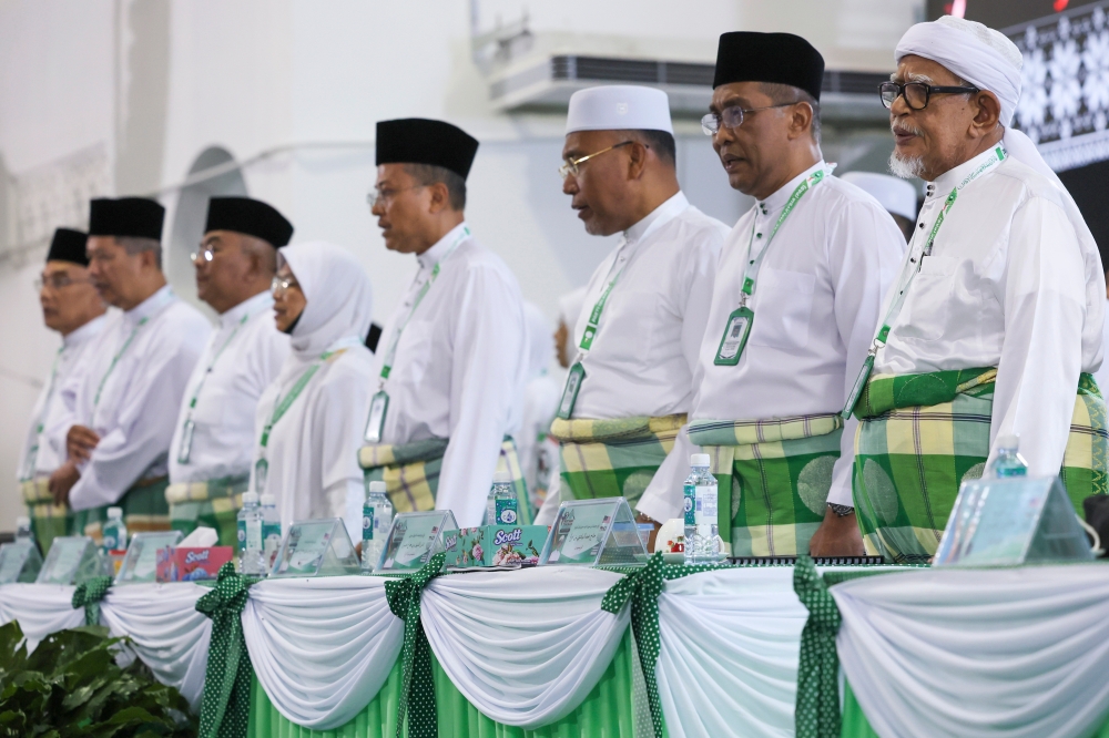PAS president Tan Sri Abdul Hadi Awang, alongside senior PAS leaders, sings the national anthem and party song at the opening of PAS’ 70th muktamar in Temerloh September 14, 2024. — Bernama pic