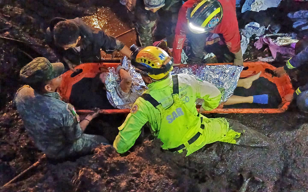 This handout photo released by the Mexican Red Cross on September 14, 2024 shows rescue team members carrying an injured person after of landslide in Jilotzingo, Mexico State. — AFP pic