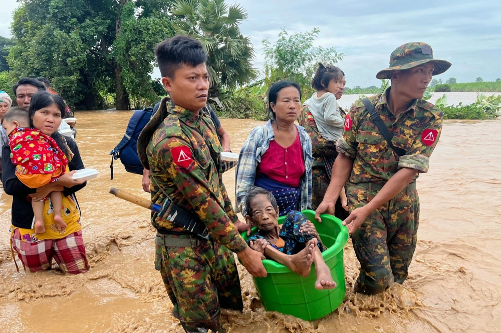 Soldiers in Pyinmana help residents in Myanmar’s Naypyidaw region to safety after Typhoon Yagi dumps an unprecedented amount of rain causing floods and landslides across the country, killing hundreds and displacing thousands more in September 2024. — AFP pic