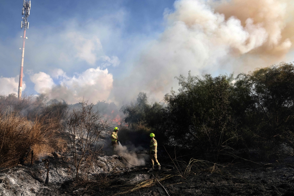 First responders put out a fire in an open area in Lod near Tel Aviv, reportedly caused by a missile fired from Yemen on September 15, 2024. — AFP pic 