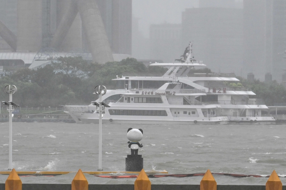 Moored boats (background) are seen past waves and whitecaps on the Huangpu river during the passage of Typhoon Bebinca in Shanghai on September 16, 2024.  — AFP pic