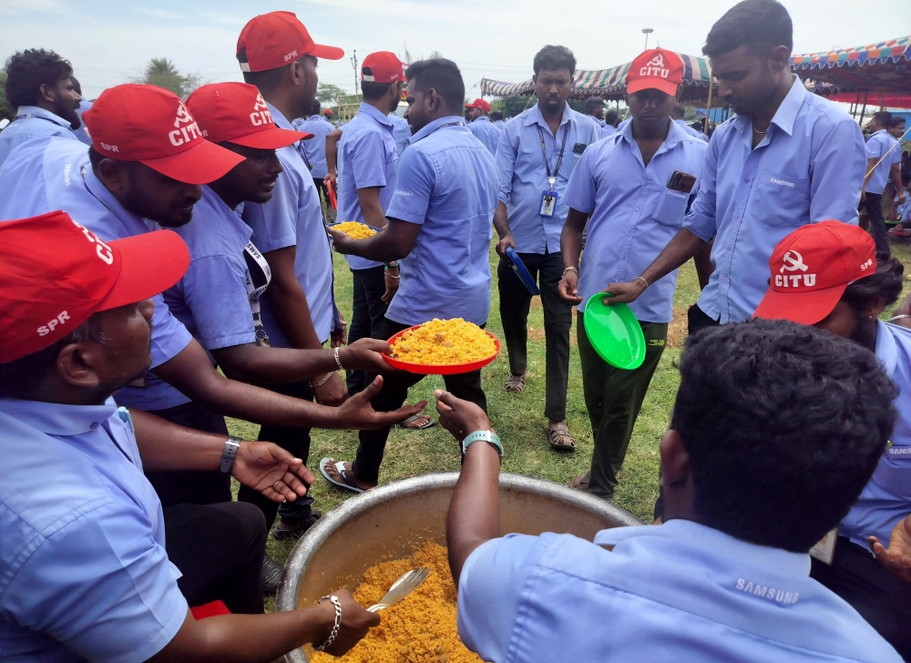 Workers of a Samsung facility serve lunch to their colleagues during a strike to demand higher wages at its Sriperumbudur plant near the city of Chennai, India, September 11, 2024. — Reuters pic