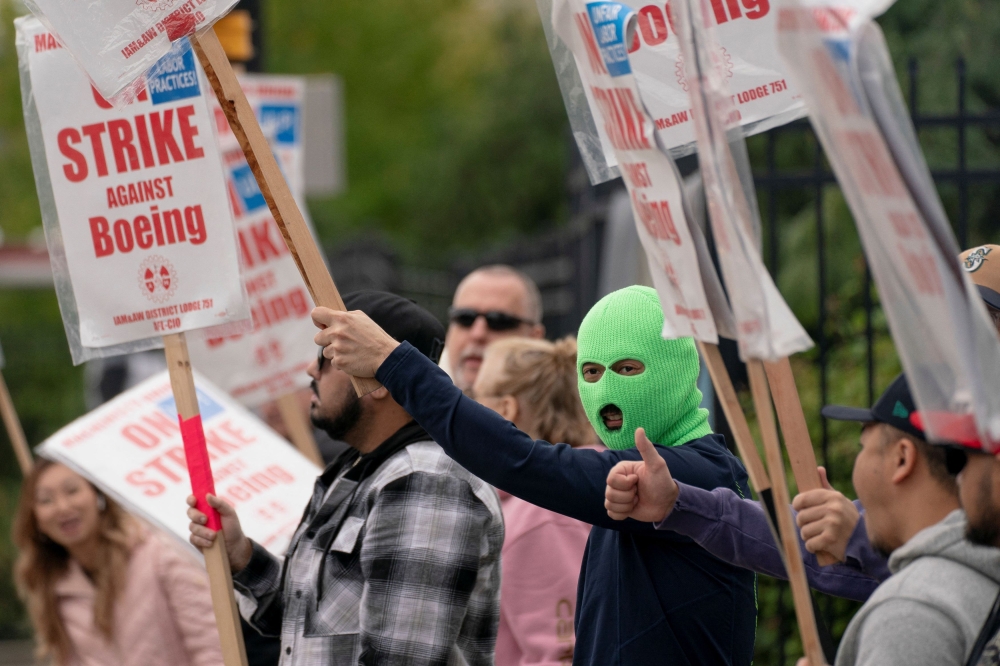 Boeing factory workers and supporters gather on a picket line during the third day of a strike near the entrance to a Boeing production facility in Renton, Washington September 15, 2024. — Reuters pic  