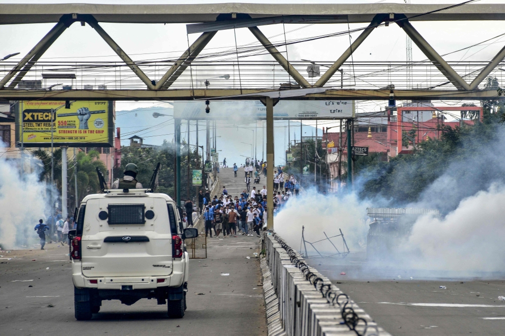 Security personnel fire tear gas shells to disperse protesters during a curfew in Imphal on September 10, 2024. India's strife-torn northeastern state of Manipur ordered an internet blackout on September 10, after imposing a curfew following days of deadly ethnic violence and clashes between protesters and police. — AFP pic