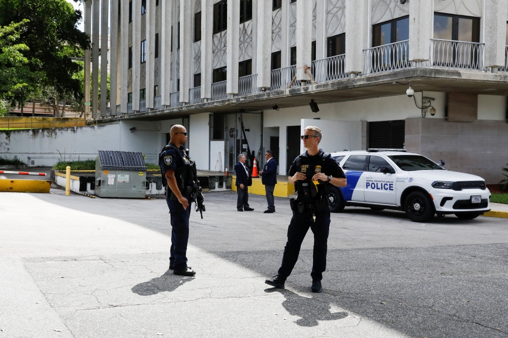 Police officers stand outside the Paul G Rogers Federal Building US Courthouse, on the day of court appearance for Ryan W. Routh, the reported suspect in an apparent assassination attempt on Republican presidential nominee and former US President Donald Trump, in West Palm Beach, Florida September 16, 2024. — Reuters pic  