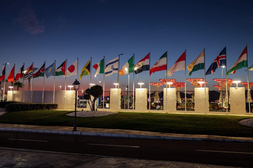 The flags of United Nations member states (from left) Hungary, Iceland, India, Indonesia, Iran, Iraq, Ireland, Israel, Italy, Jamaica, Japan, Jordan, Kazakhstan, Kenya, Kiribati, Kuwait, Kyrgyzstan, and Laos fly in alphabetical order during the COP27 climate conference at the Sharm el-Sheikh International Convention Centre, in Egypt's Red Sea resort city of the same name, on November 7, 2022. — AFP pic