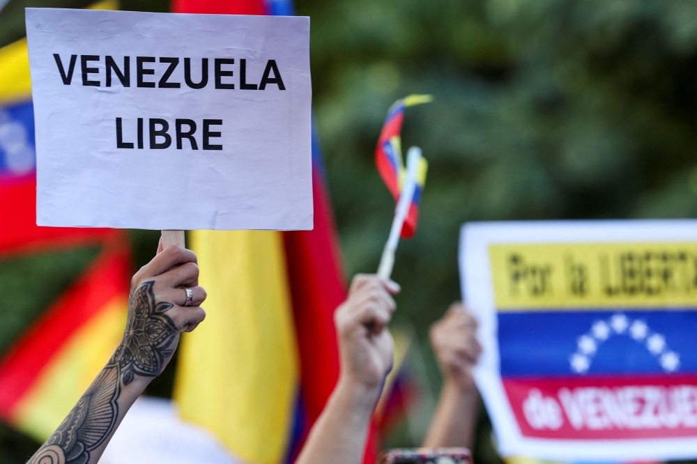A person holds a placard that reads ‘Free Venezuela’, as Venezuelans living in Spain take part in a gathering outside Spanish parliament in support of opposition presidential candidate Edmundo Gonzalez, in the aftermath of disputed Venezuelan elections, in Madrid September 10, 2024. — Reuters pic  