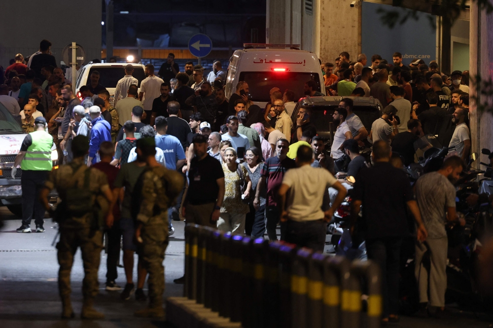People gather at the entrance of the American University of Beirut Medical Center, on September 17, 2024, after explosions hit locations in several Hezbollah strongholds around Lebanon amid ongoing cross-border tensions between Israel and Hezbollah fighters. — AFP pic