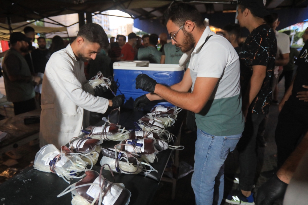 Medics collect blood donations in Beirut’s southern suburb on September 17, 2024, after explosions hit locations in several Hezbollah strongholds around Lebanon amid ongoing cross-border tensions between Israel and Hezbollah fighters. — AFP pic