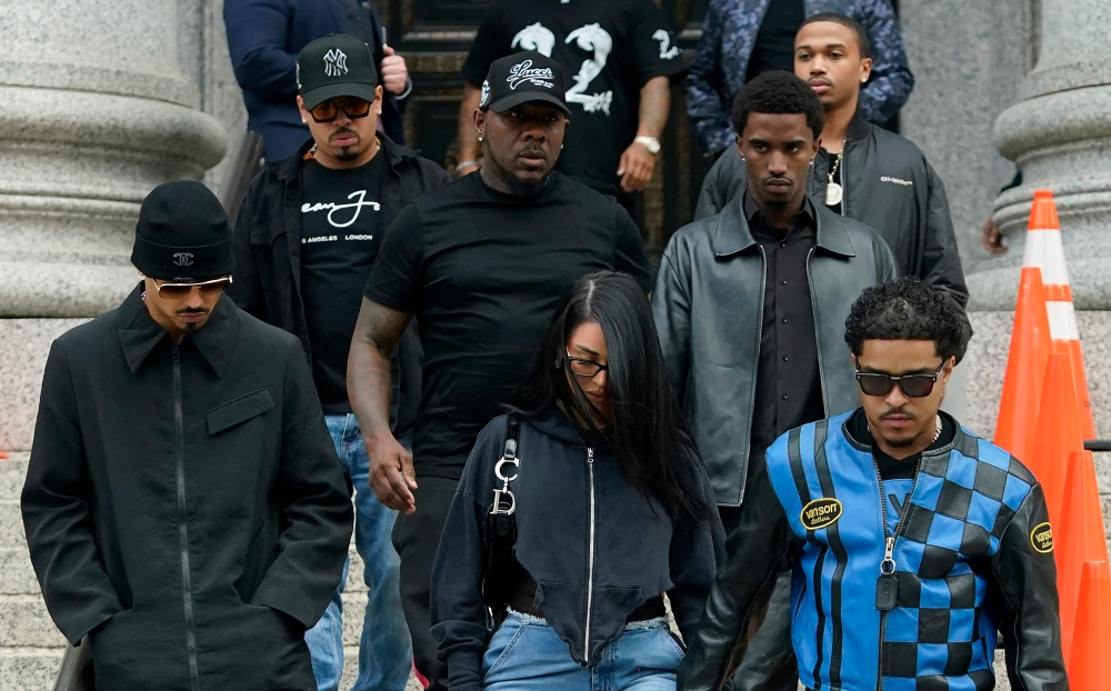 Justin Combs (right) and Christian Combs (second from right), sons of the rapper leaving the court after their father's bail hearing in New York. — AFP