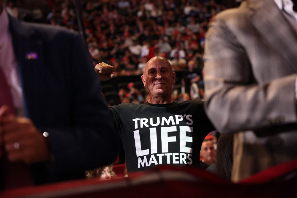 Supporters watch and cheer as Republican presidential nominee, former U.S. President Donald Trump speaks at an evening rally in Uniondale on Long Island on September 18, 2024 in Uniondale, New York. — AFP pic