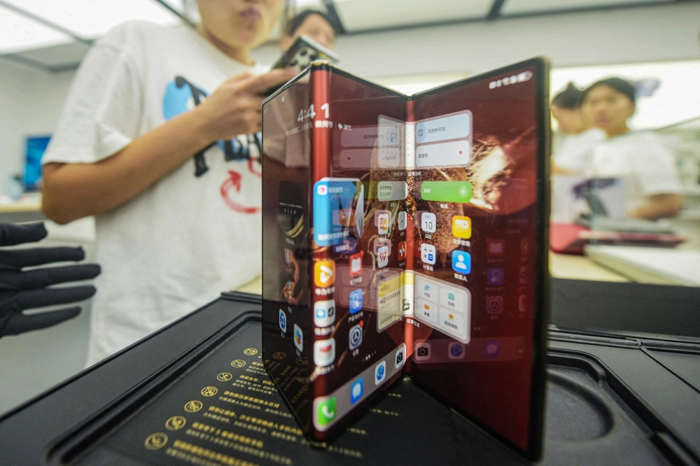 Chinese tech giant Huawei’s new trifold phone Huawei Mate XT is displayed during its launch day at a Huawei store in Hangzhou, in eastern China’s Zhejiang province on September 10, 2024. — AFP pic 