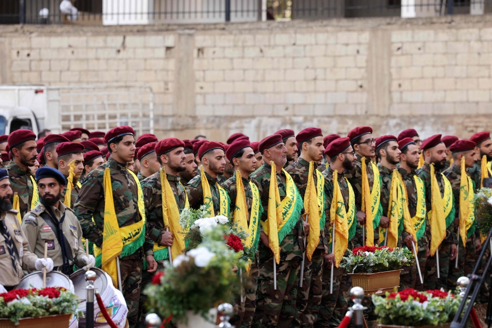 Hezbollah fighters attend the funeral of persons killed after hundreds of paging devices exploded in a deadly wave across Lebanon the previous day, in Beirut's southern suburbs on September 18, 2024. — AFP pic