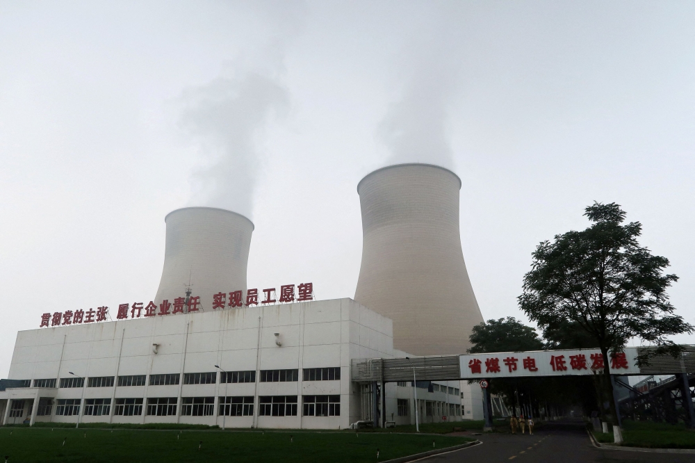 Water vapour rises from cooling towers of a China Energy ultra-low emission coal-fired power plant in Sanhe, Hebei province, China July 18, 2019. — AFP pic