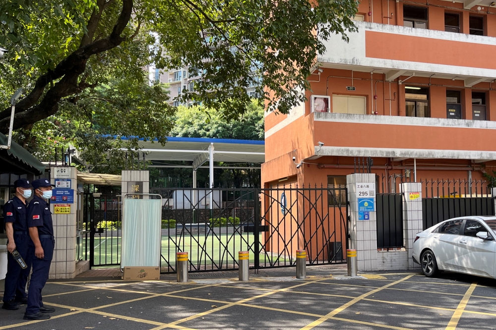 Security personnel keep watch outside Shenzhen Japanese School, following the death of a 10-year-old child after being stabbed by an assailant on the way to the school, in Shenzhen, Guangdong province, China September 19, 2024. — Reuters pic