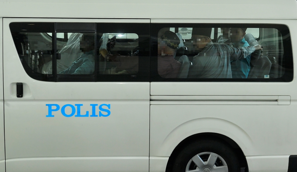 A total of 19 individuals linked to Global Ikhwan Services and Business Holdings (GISBH) are brought to the Shah Alam Magistrates’ Court in Shah Alam September 19, 2024. — Bernama pic