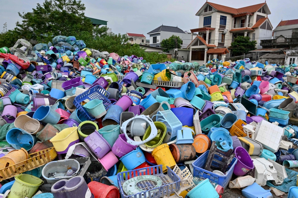 Piles of plastic waste are pictured at a recycling site next to a residential area on the outskirts in Hanoi on September 17, 2024. — AFP pic