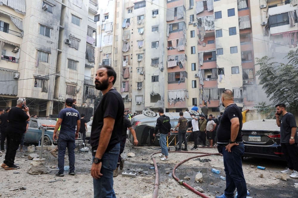 People inspect the site of an Israeli strike in the southern suburbs of Beirut, Lebanon, September 20, 2024. — Reuters pic