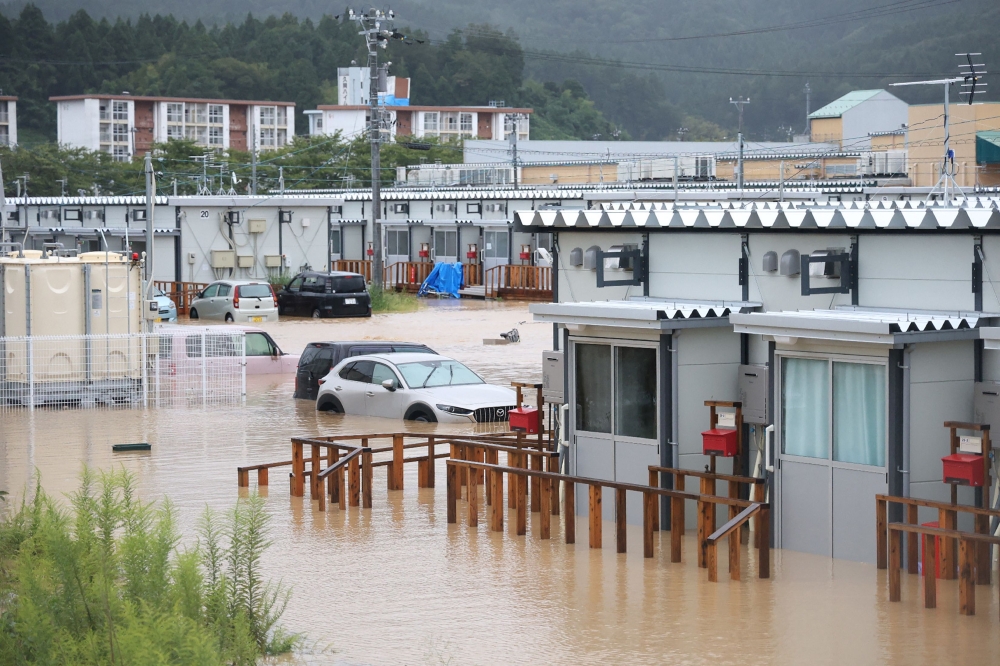 This photo shows temporary housing - built for people who lost their homes during the January 1, 2024 earthquake - surrounded by floodwaters after heavy rains pounded the area, in the city of Wajima, Ishikawa prefecture, on September 22, 2024. — AFP pic