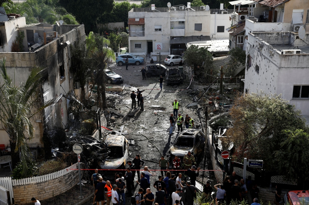 Emergency personnel work at a site of houses damaged following a rocket attack from Lebanon, amid cross-border hostilities between Hezbollah and Israel, in Kiryat Bialik, Israel, September 22, 2024. — Reuters pic
