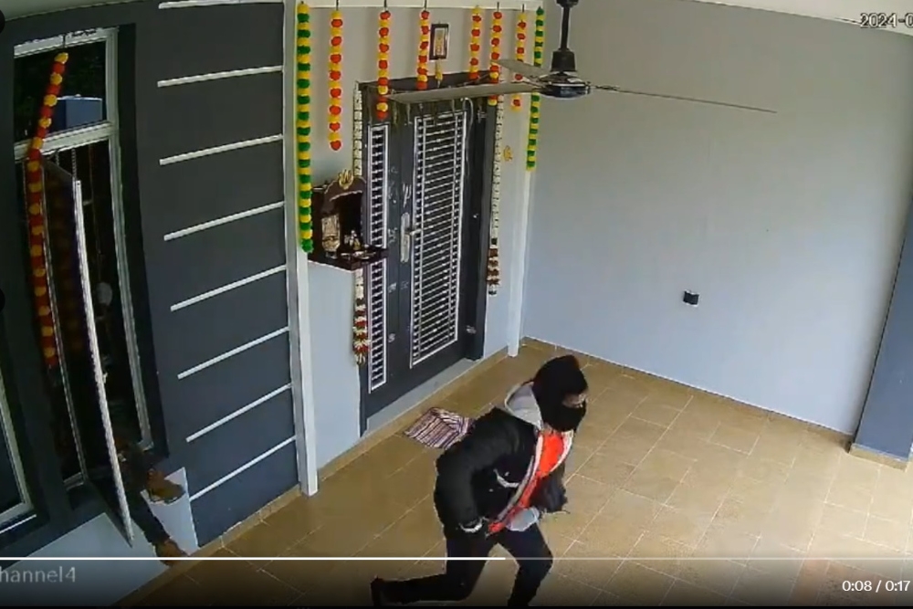 A screengrab showing the masked suspects leaving a house they had burgled. 