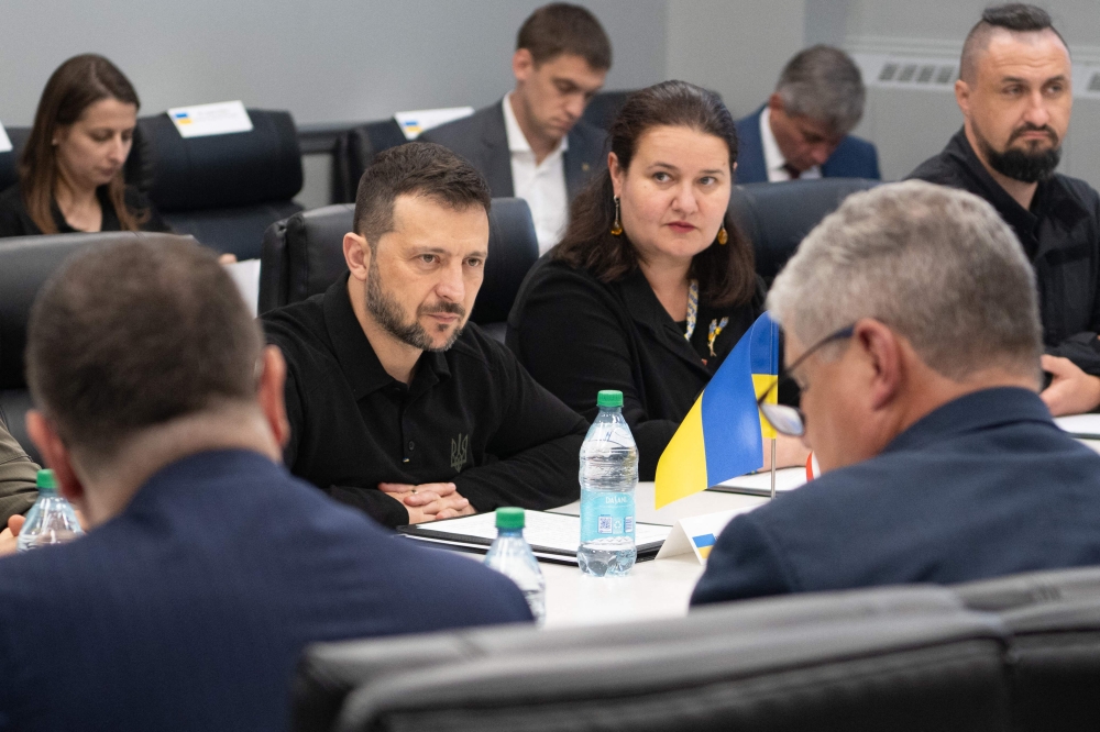 This handout photo released by the US Army shows Ukrainian President Volodymyr Zelensky listening to the US delegation while at the Scranton Army Ammunition Plant in Scranton, Pennsylvania September 22, 2024. — SFC. Curt Loter/US Army/AFP pic