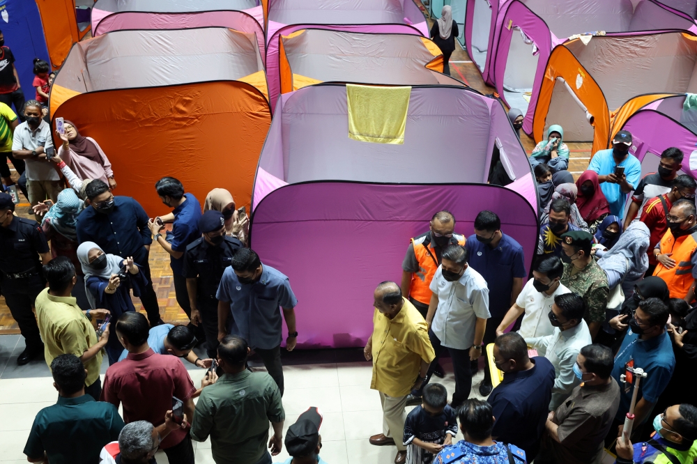 Sultan Kedah Al-Aminul Karim Sultan Sallehuddin Sultan Badlishah (in yellow shirt, centre right) spent about an hour speaking to the flood-struck residents sheltering at Stadium Sultan Abdul Halim in Alor Setar on September 23, 2024. — Bernama pic