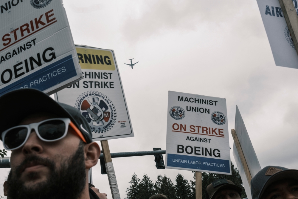 Striking Boeing workers hold placards at the Boeing Portland Facility on September 19, 2024, in Oregon, the United States. — AFP pic