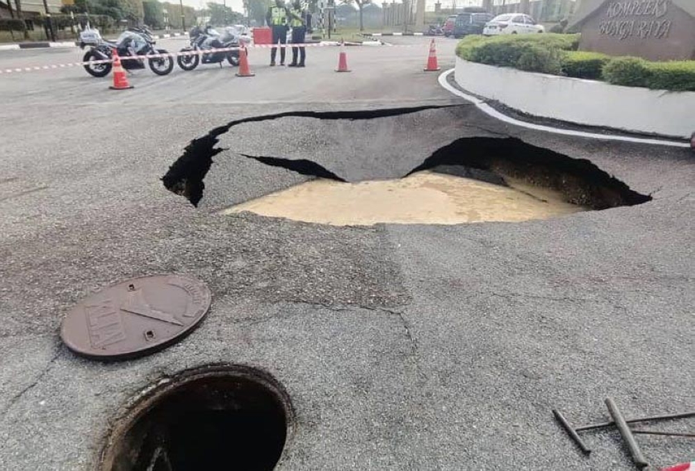 The sinkhole, estimated to be around one metre deep with a width of 5.4 metres and a length exceeding four metres, was located near a KLIA sewage manhole, raising suspicions of a potential sewage pipe leak as the cause. — Picture via Facebook
