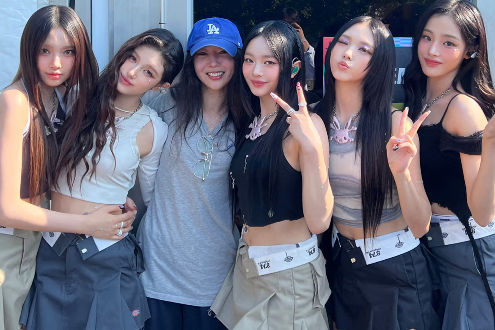 Min Hee-jin (in baseball cap) claimed that HYBE offered to pay her to leave the company.  — Image courtesy of ADOP