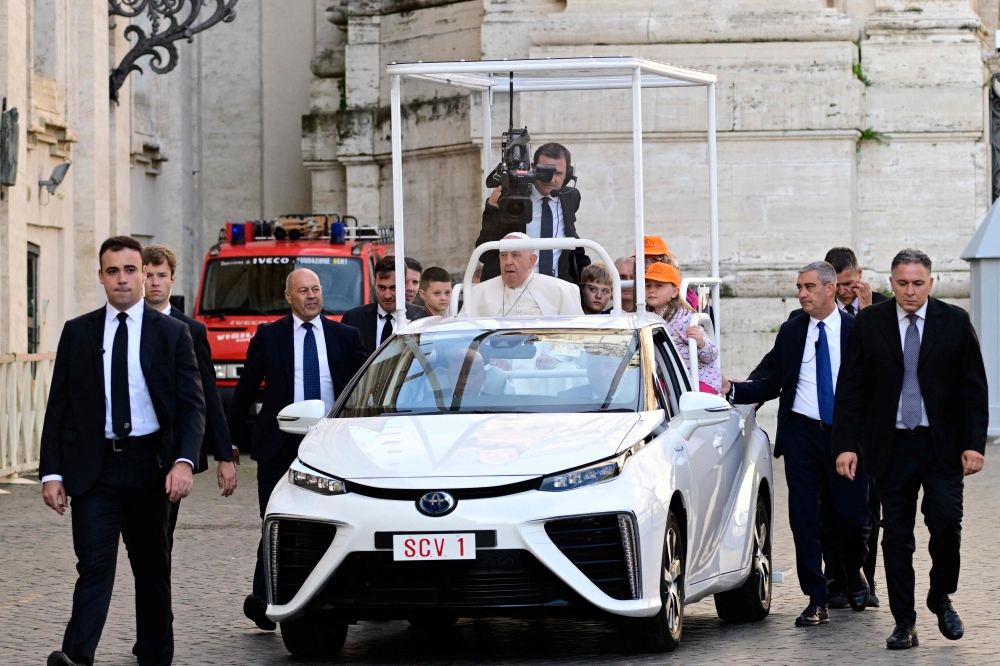 Pope Francis arrives on a Toyota Mirai hydrogen-powered popemobile for the weekly general audience on September 25, 2024 at St Peter's square in The Vatican. — AFP pic
