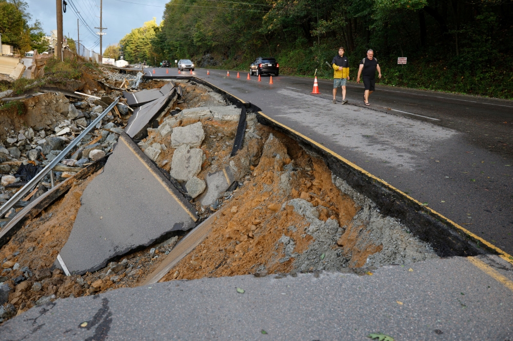 A large section of Highway 105 that washed away because of flood waters in the outskirts of Boone, North Carolina. — Reuters pic