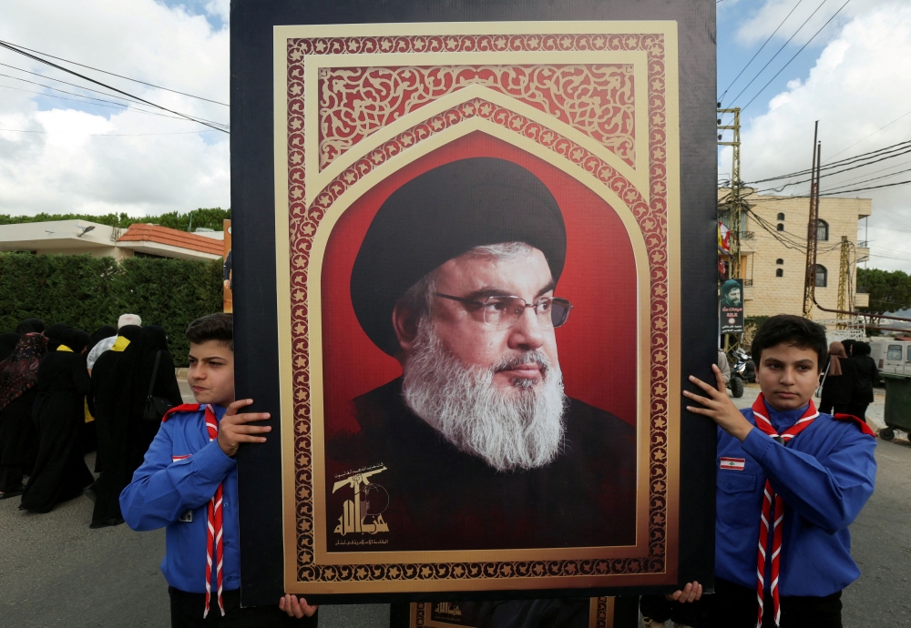 Boys scouts carrying a picture of Hezbollah leader Sayyed Hassan Nasrallah. — Reuters pic