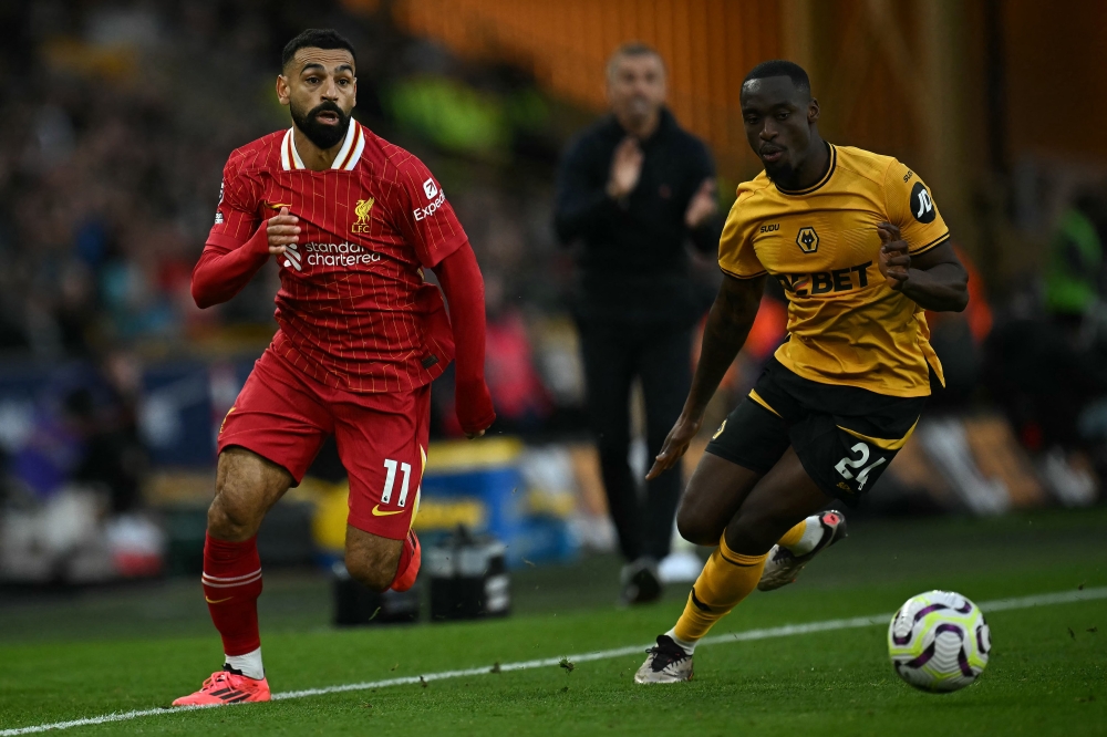 Wolverhampton Wanderers’ Tote Gomes vies with Mohamed Salah during their Premier League match in Wolverhampton September 28, 2024. — AFP pic