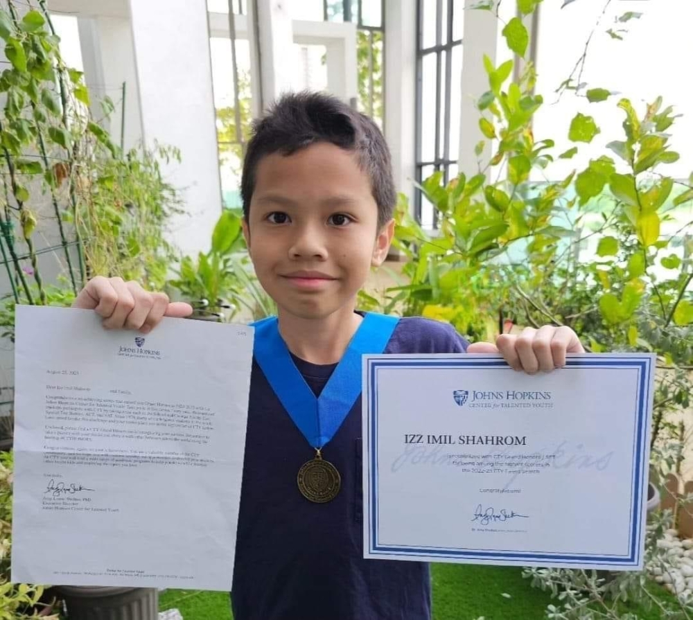 An undated photo of Iz Emir showing his certificate from the John Hopkins Centre for Talented Youth. — Picture from Facebook/ Rosmah Mansor