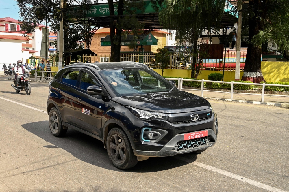 Taxi driver Surendra Parajuli’s decision to buy an electric car would have been unthinkable a decade ago, when chronic power cuts left Nepalis unable to light their homes at night. — AFP pic