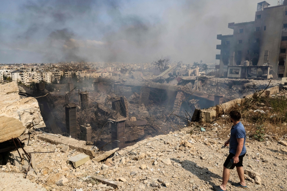 A man checks the destruction at a factory targeted in an overnight Israeli airstrike in the town of Chouaifet south of Beirut on September 28, 2024. — AFP pic