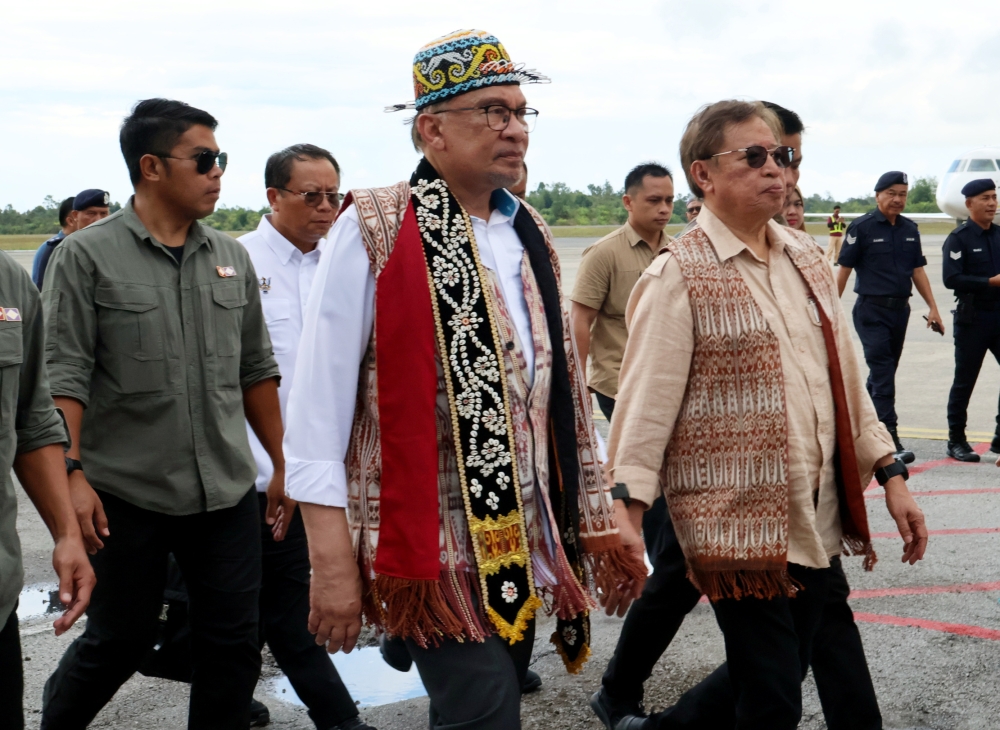 Datuk Seri Anwar Ibrahim (left) is escorted by Sarawak Premier Tan Sri Abang Johari Openg during the prime minister’s visit to Kapit on September 29, 2024. — Bernama pic 