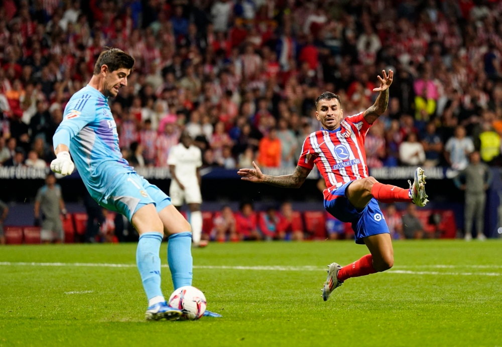 Real Madrid’s Thibaut Courtois in action with Atletico Madrid’s Angel Correa at Metropolitano, Madrid, September 29, 2024. — Reuters pic 
