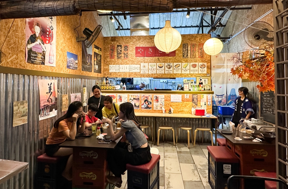 It feels like Japan in Sumitaro Yakitori Izakaya until you walk out and see the acupuncturist and Chinese temple. — Picture by Lee Khang Yi