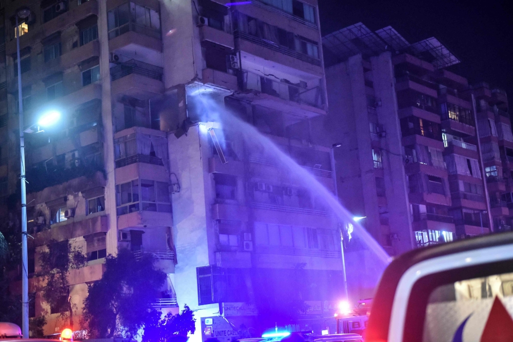 Firefighters douse the flames of an apartment building hit by an Israeli air strike in Beirut’s Kola district, September 30, 2024. Two people were killed in an Israeli strike on Beirut on September 30, a Lebanese security source said, the first strike on the city itself since the October 7 Hamas attack on Israel last year. — AFP pic 