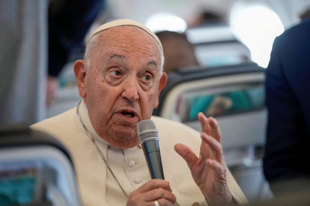 Pope Francis talks to journalists on the flight back to Rome at the end of his four-day visit to Belgium and Luxembourg, September 29, 2024. — Reuters pic 