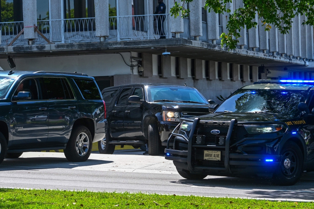 A motorcade believed to be carrying Ryan Wesley Routh, suspected of the attempted assassination of former US president Donald Trump, departs the Paul G. Rogers Federal Building and US Courthouse following Routh's detention hearing in West Palm Beach, Florida, on September 30, 2024. — AFP pic