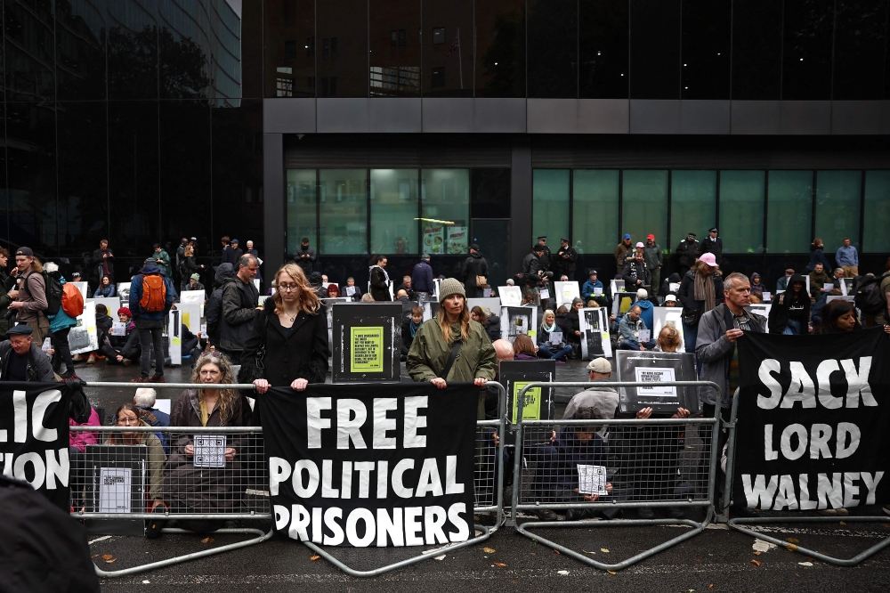 Supporters of the two Just Stop Oil environmental protesters, Phoebe Plummer and Anna Holland gather with placards outside Southwark Crown Court in London on September 27, 2024, during their sentencing. A UK judge on Friday jailed two climate activists who threw soup at Vincent van Gogh's 