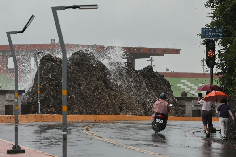 A person takes photos of the wave as Typhoon Krathon approaches Kaohsiung, Taiwan October 1, 2024. — Reuters pic