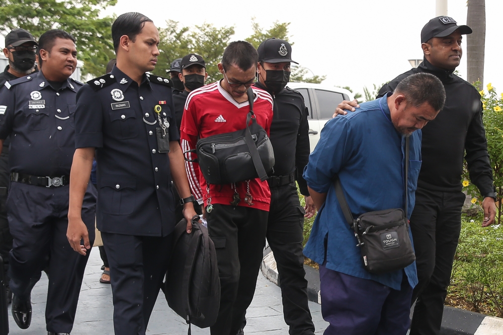 Four men linked to GISB Holdings Sdn Bhd (GISBH) are escorted by police as they arrive to be charged with child abuse at the Klang Sessions Court on September 26, 2024. — Picture by Yusof Mat Isa