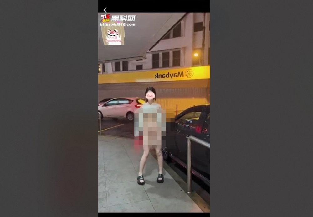 A 10-second clip showing the woman lifting up her clothes and posing in front of the signboard was believed to have been posted on a Chinese website, but is now making its rounds through WhatsApp.
